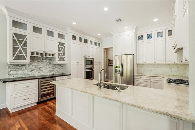 kitchen featuring sink, appliances with stainless steel finishes, white cabinetry, wine cooler, and kitchen peninsula