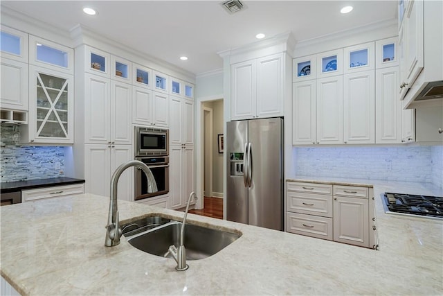 kitchen featuring stainless steel appliances, light stone countertops, and white cabinets