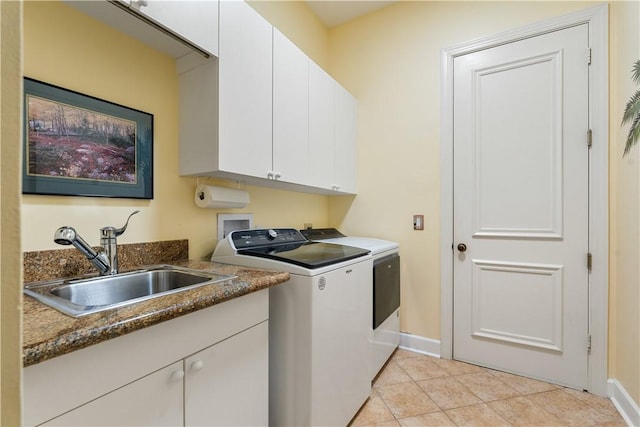 washroom featuring cabinets, independent washer and dryer, sink, and light tile patterned floors