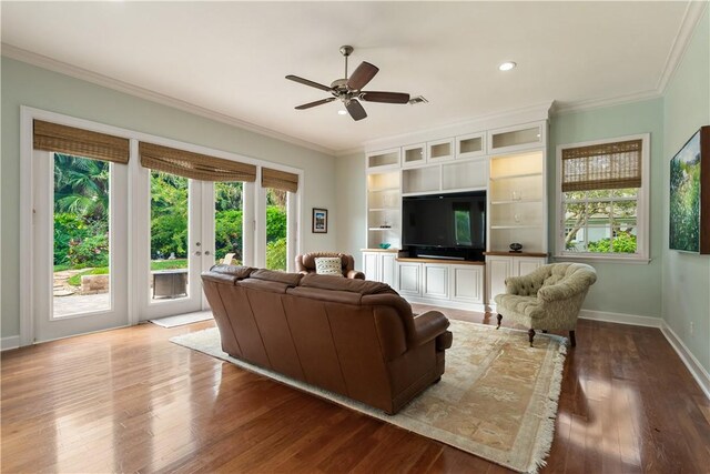 living room with light hardwood / wood-style flooring and ornamental molding