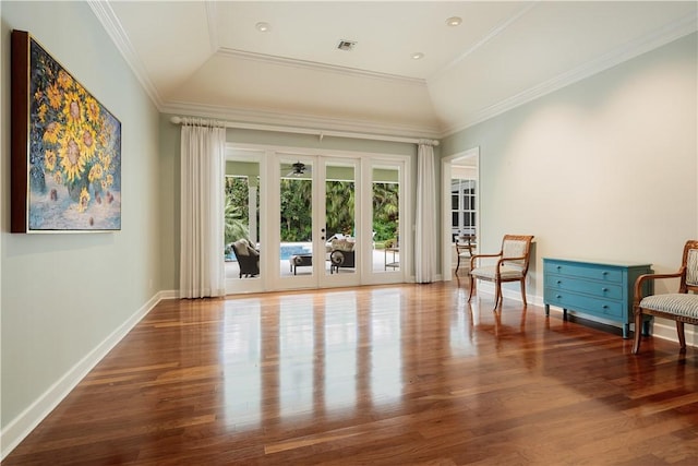 living area featuring lofted ceiling, crown molding, hardwood / wood-style floors, a raised ceiling, and french doors