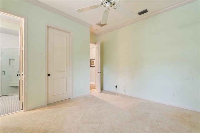 unfurnished bedroom featuring light carpet, connected bathroom, crown molding, and ceiling fan