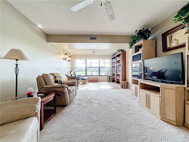 living room featuring a textured ceiling, light carpet, and ceiling fan