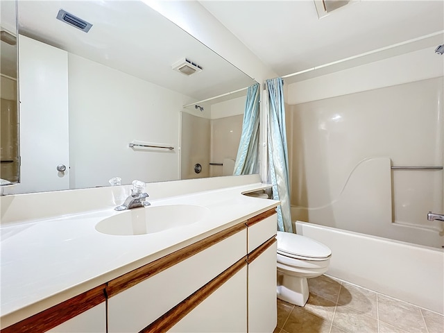 full bathroom featuring toilet, vanity, shower / bath combo with shower curtain, and tile patterned floors