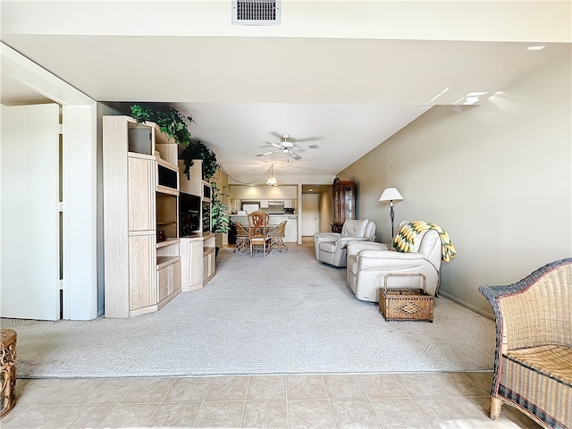 living room featuring ceiling fan and light colored carpet