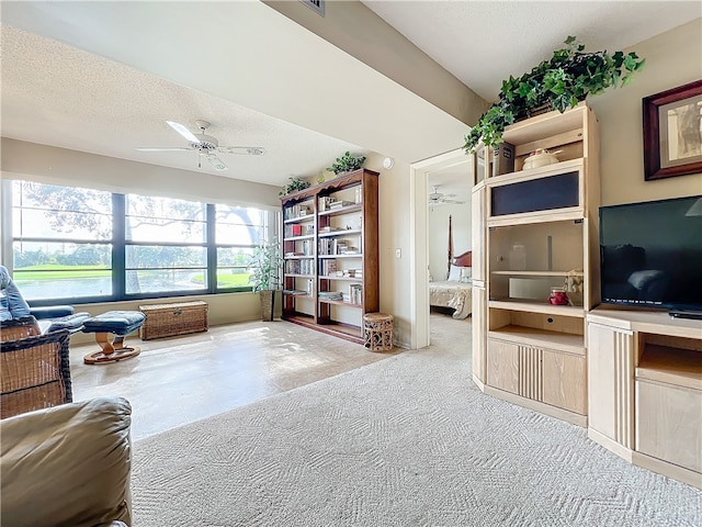 interior space with carpet flooring, a textured ceiling, and ceiling fan