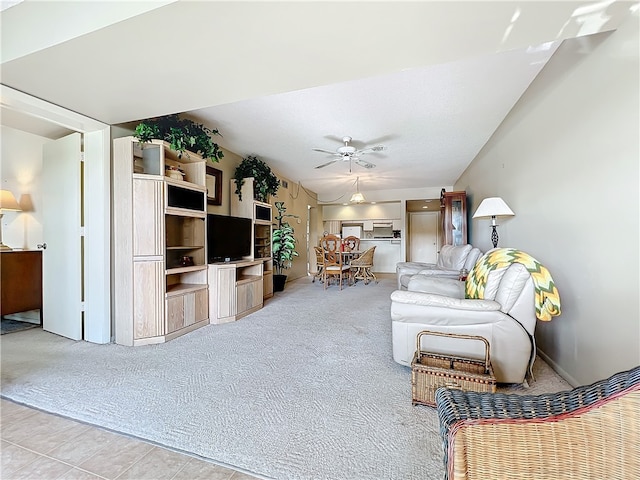 tiled living room with ceiling fan