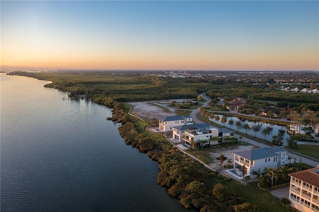 aerial view at dusk with a water view