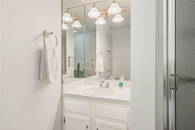 bathroom with toilet, a shower with shower door, and vanity