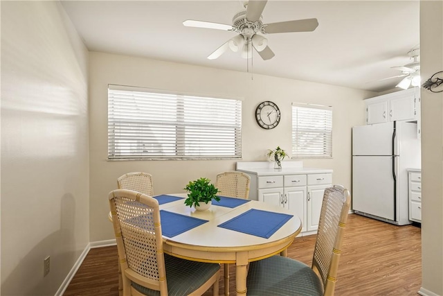 dining area featuring ceiling fan and light wood-type flooring