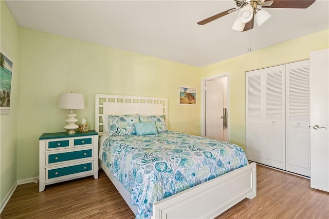 bedroom with hardwood / wood-style floors, a closet, and ceiling fan