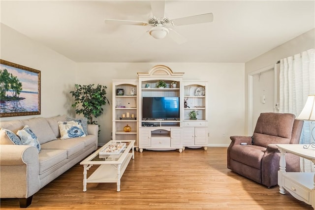 living room with light wood-type flooring and ceiling fan