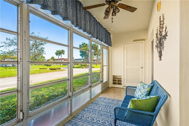 sunroom / solarium featuring ceiling fan