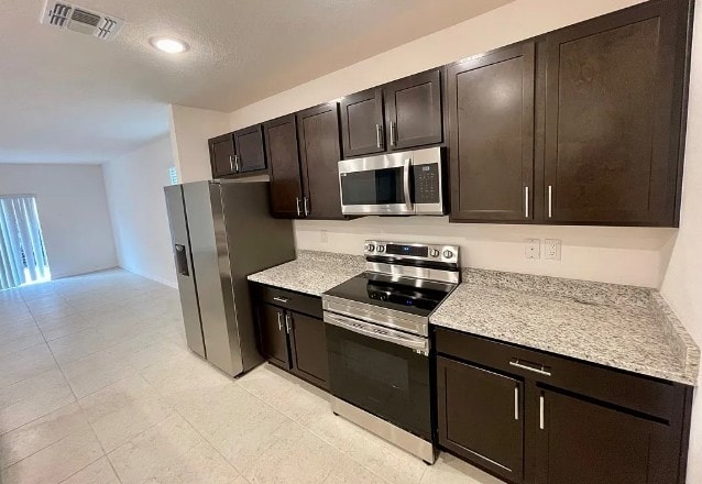 450 Hazel St, Sebastian, FL 32958 - kitchen featuring stainless steel appliances, dark brown cabinetry, and recessed lighting