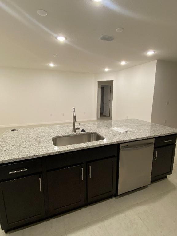 450 Hazel St, Sebastian, FL 32958 - kitchen with stainless steel dishwasher, dark cabinets, light stone countertops, and recessed lighting