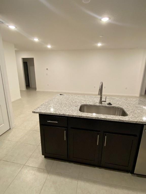 450 Hazel St, Sebastian, FL 32958 - kitchen featuring dishwashing machine, light stone countertops, light tile patterned floors, and recessed lighting