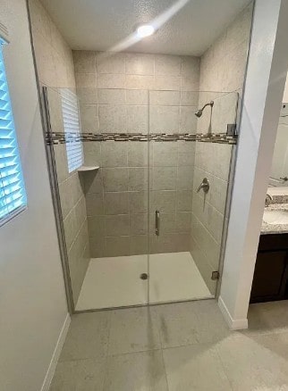 450 Hazel St, Sebastian, FL 32958 - bathroom with a stall shower, vanity, and tile patterned flooring