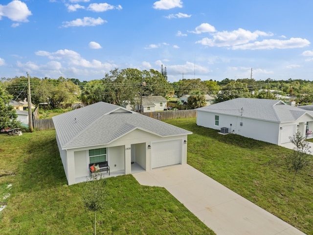 view of front of home featuring a garage, central AC unit, and a front lawn