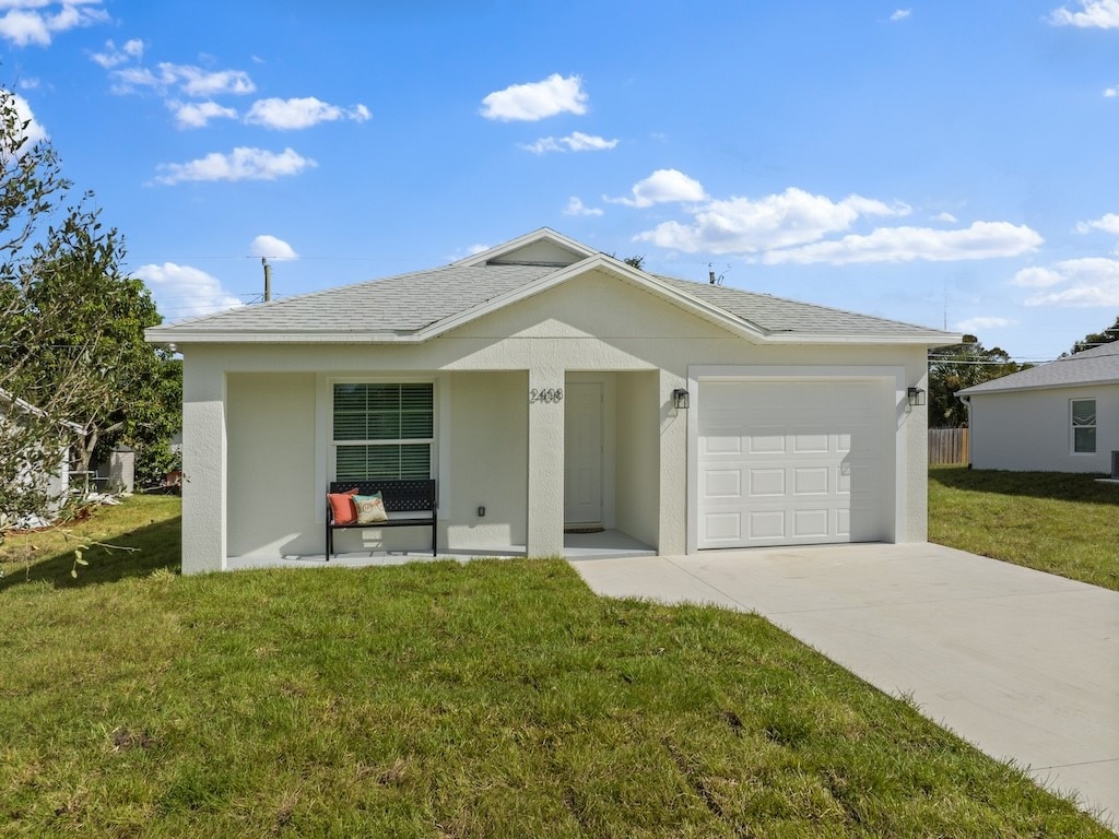 ranch-style home with a front yard and a garage