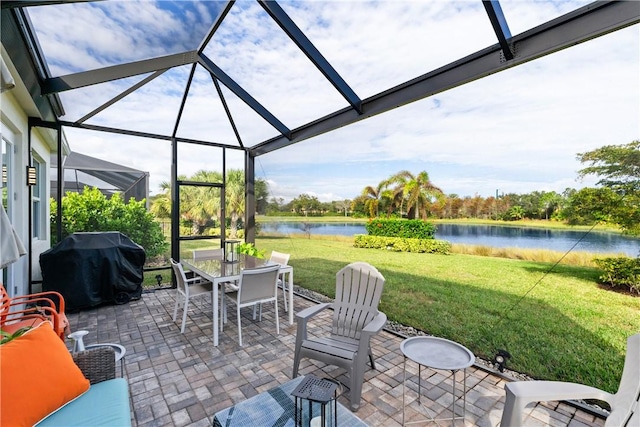 view of patio featuring glass enclosure, a grill, and a water view