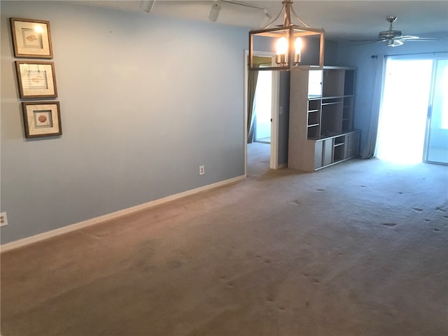 unfurnished living room with ceiling fan and carpet floors