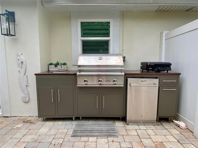 view of patio / terrace with an outdoor kitchen, sink, and grilling area