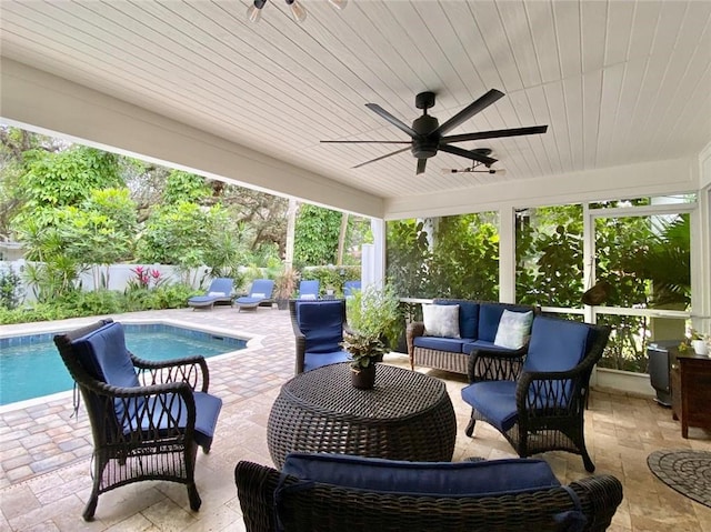 view of patio / terrace with a fenced in pool, outdoor lounge area, and ceiling fan