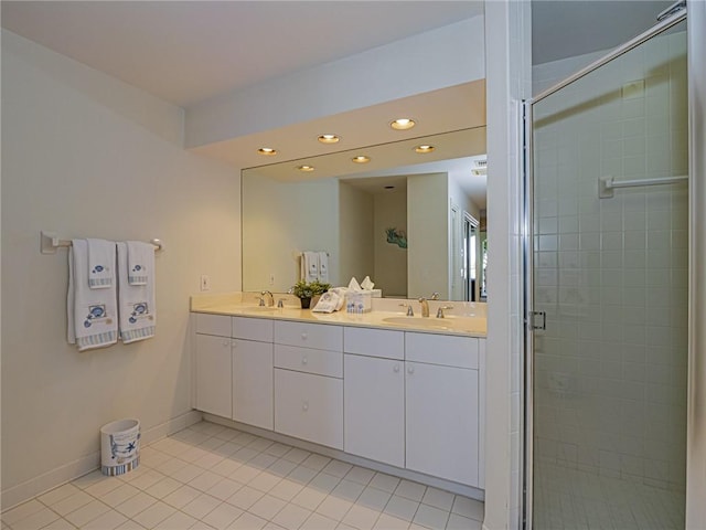 bathroom with tile patterned floors, an enclosed shower, and vanity