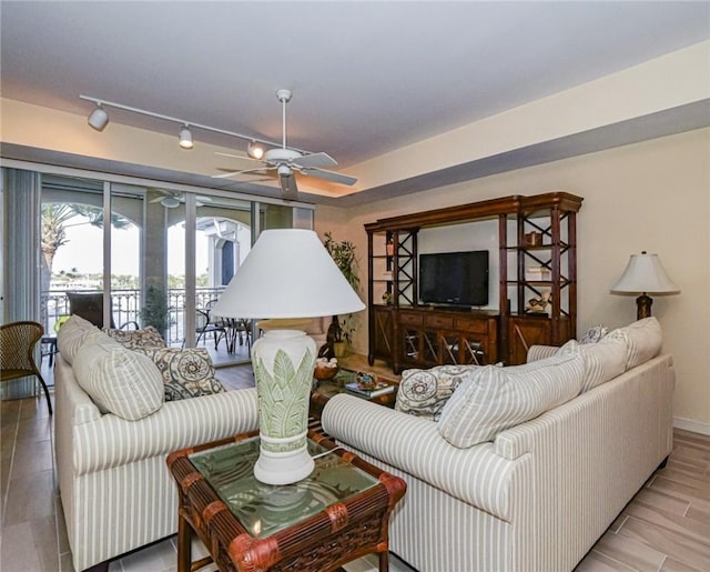 living room with ceiling fan and rail lighting