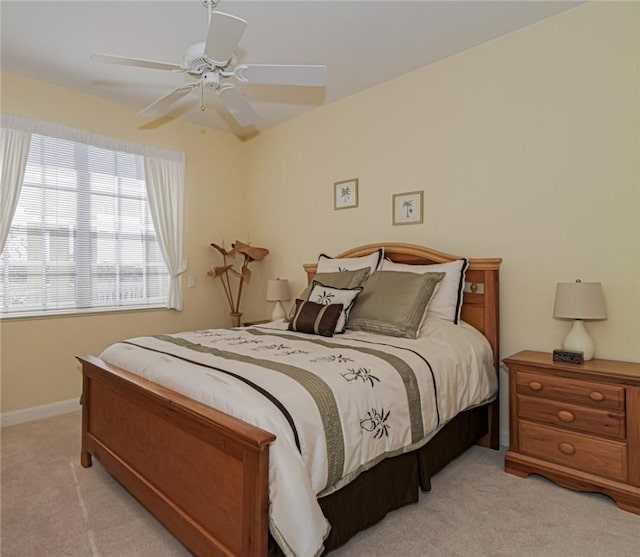 bedroom featuring ceiling fan and light colored carpet