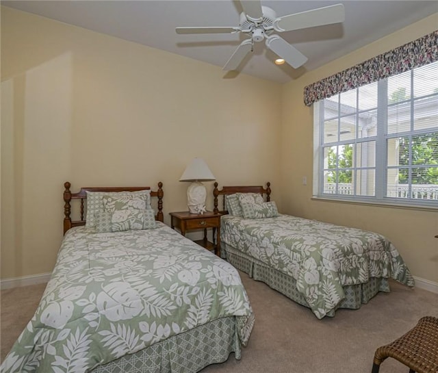 bedroom featuring ceiling fan and light colored carpet