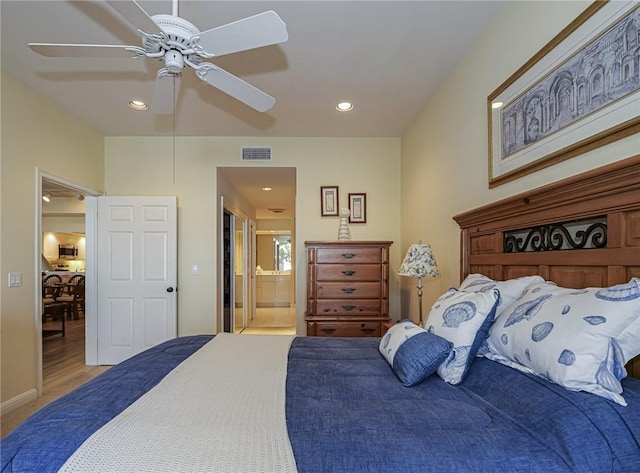 bedroom featuring ceiling fan and connected bathroom