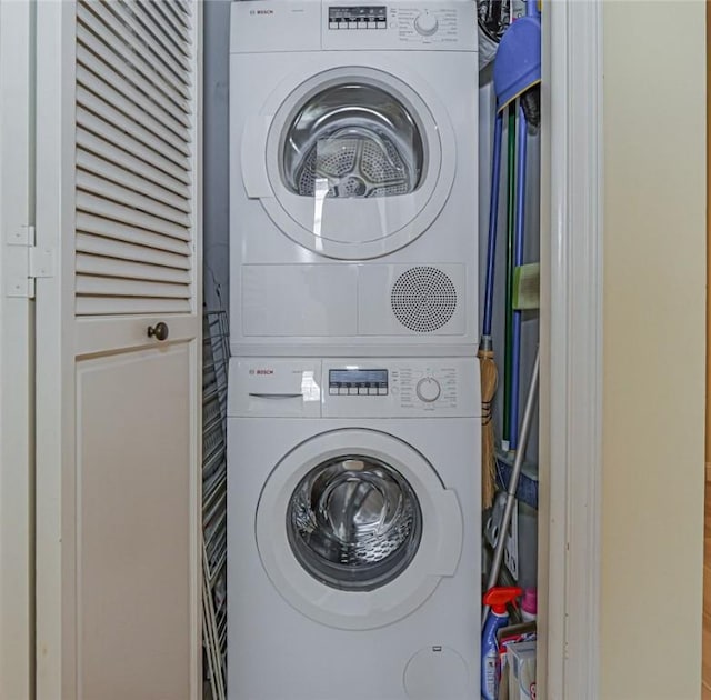 laundry area featuring stacked washing maching and dryer