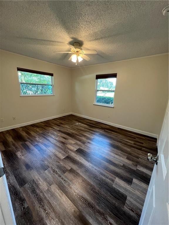 unfurnished room with a healthy amount of sunlight, a ceiling fan, a textured ceiling, and wood finished floors
