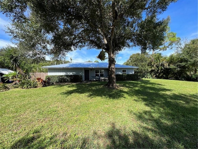 back of property with fence and a yard