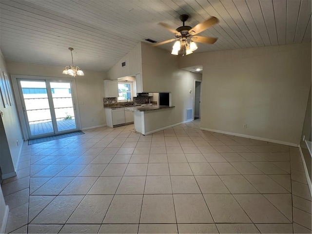 kitchen featuring open floor plan, visible vents, dark countertops, and lofted ceiling