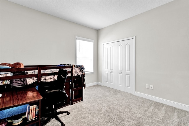 carpeted office space featuring a textured ceiling