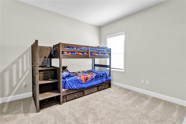 bedroom with carpet floors and a textured ceiling