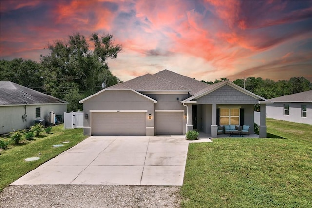 view of front of home featuring a garage and a yard