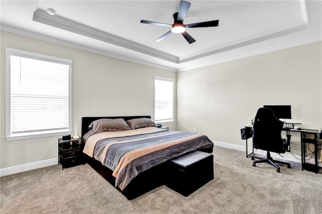 bedroom with a raised ceiling, ornamental molding, light carpet, and a textured ceiling