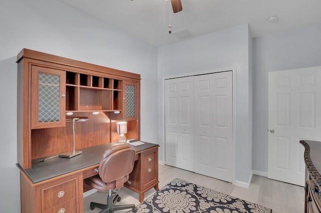 office with light wood-type flooring, baseboards, and a ceiling fan