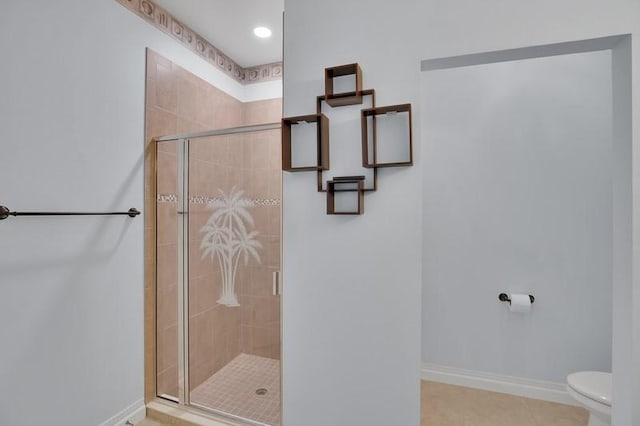 full bathroom with baseboards, toilet, a shower stall, and tile patterned flooring