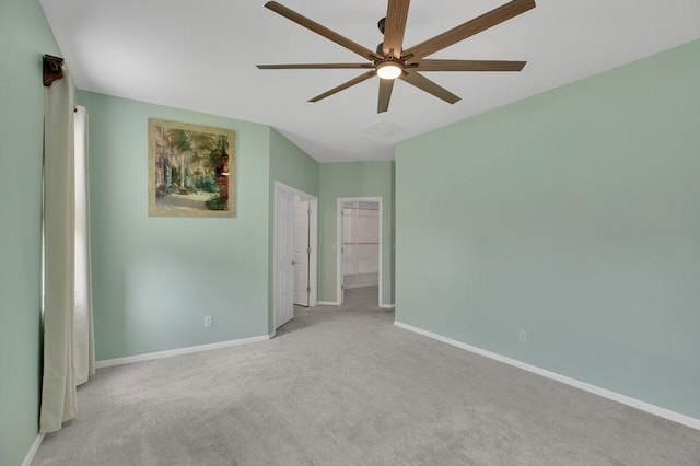 spare room with carpet flooring, baseboards, and a ceiling fan