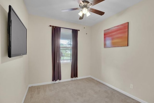 unfurnished room with a ceiling fan, baseboards, and carpet floors