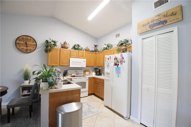 kitchen featuring white appliances, light tile patterned floors, a peninsula, and visible vents