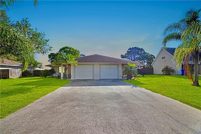 single story home with driveway, a front lawn, a garage, and fence