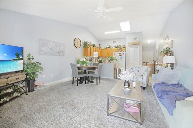 tiled living room featuring ceiling fan and vaulted ceiling