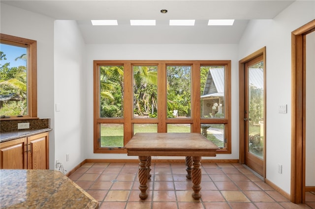 interior space featuring light tile patterned floors and vaulted ceiling