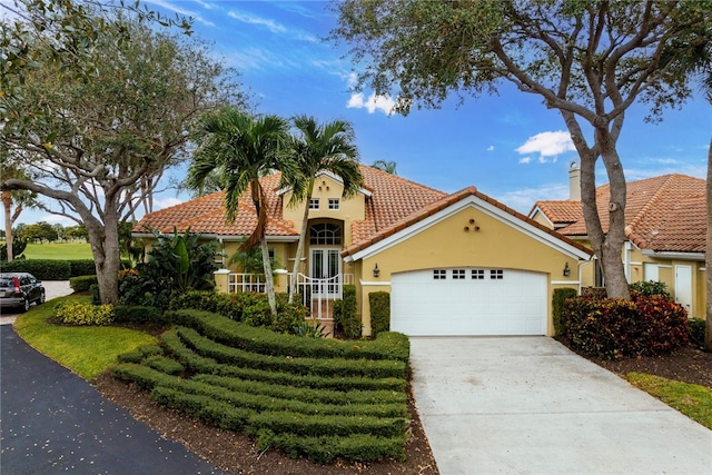 mediterranean / spanish house with a garage