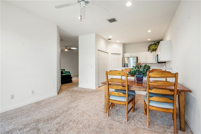 carpeted dining area featuring ceiling fan